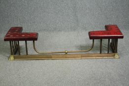 A 19th century brass and leather upholstered club fender. H.34 W.150 D.42cm.