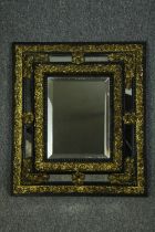 Wall mirror, late 19th century Flemish cushion frame with repousse metalwork and bevelled plate. H.
