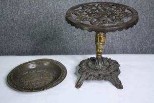 A 19th century brass and iron trivet in the form of a table and an embossed dish. H.26 Dia.26cm. (
