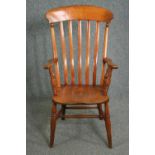 A 19th century elm seated bar back kitchen armchair. H.110cm.