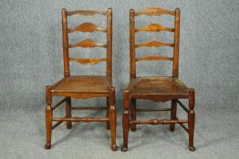 A pair of 18th century elm Lancashire ladderback dining chairs.