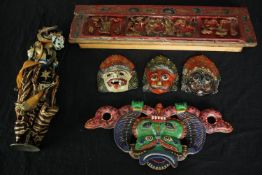 Four Balinese polychrome painted masks and a shadow puppet along with a carved and painted Chinese