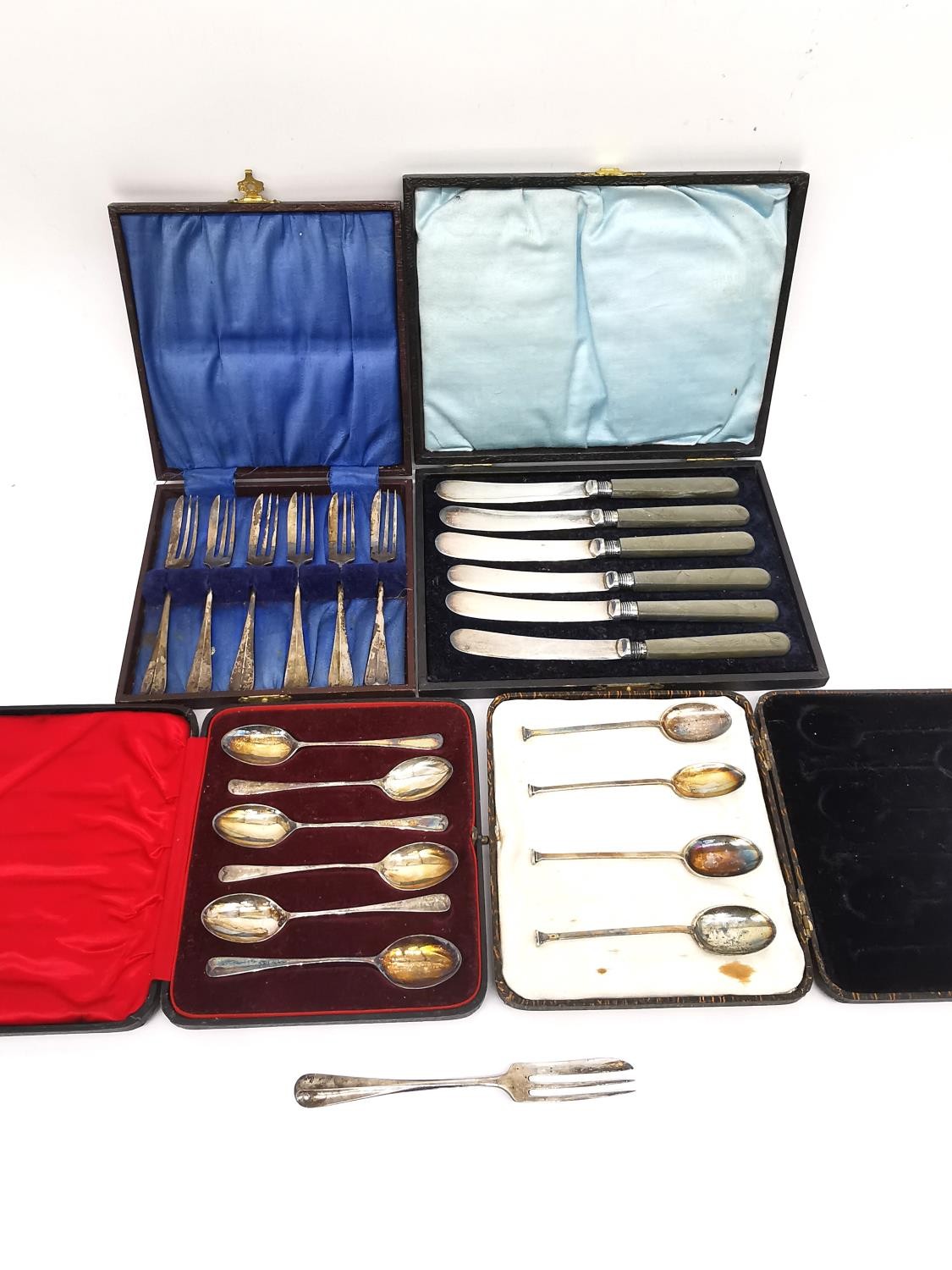 Four cased sets of silverware, six dessert knives with silver blades, a set of six teaspoons, four