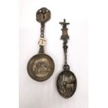 Two early 20th century silver libation spoons, one Dutch depicting a rural scene of cows and