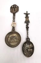 Two early 20th century silver libation spoons, one Dutch depicting a rural scene of cows and