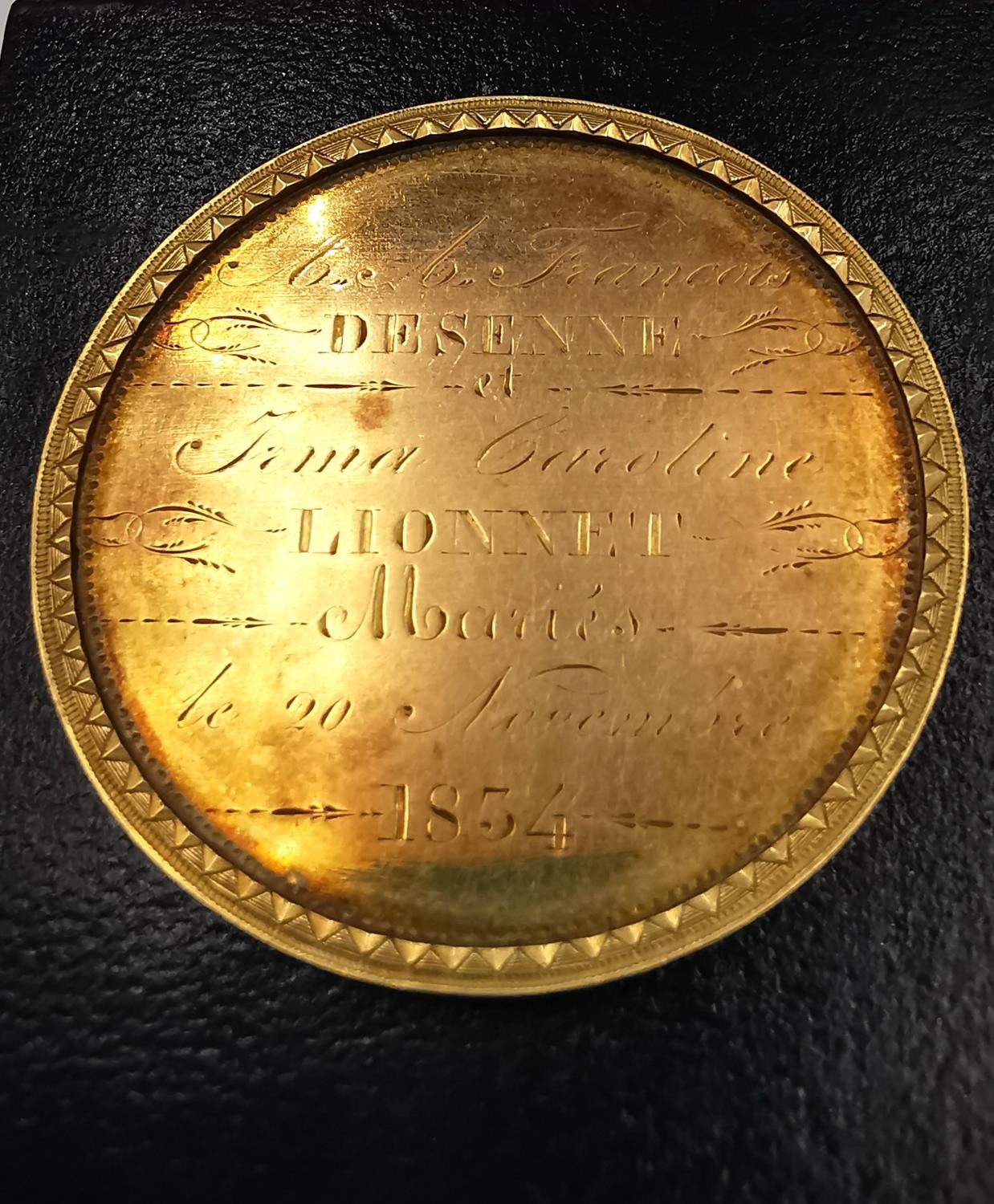 A 19th century French yellow metal (tests higher than 9ct gold) medal with raised edge and inscribed