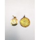 Two yellow metal st Christopher's, one Greek yellow metal (tests as 18ct) depicting Mary and Jesus