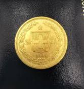 A 20F Swiss gold coin dated 1886. Diameter 2.1cm. Weight 6.44g