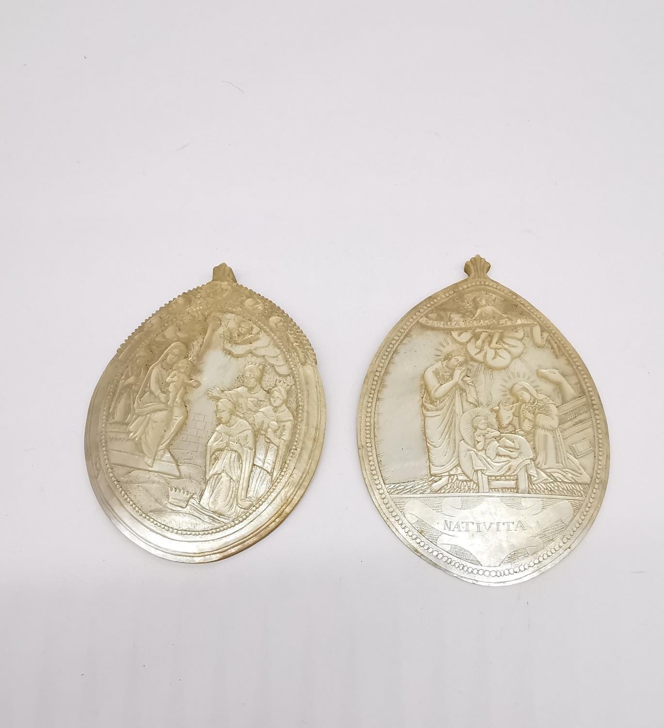 Two 19th century carved mother of pearl religious medallions depicting The Annunciation, Holy Land