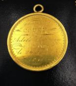 A 19th century yellow metal (tests higher than 9ct) medal with laurel leaf wreath and engraved