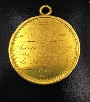 A 19th century yellow metal (tests higher than 9ct) medal with laurel leaf wreath and engraved