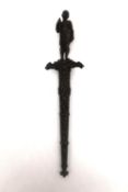 A 19th century French colonial bronze handled dagger with relief design bronze scabbard. The