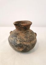 A Pre-Colombian terracotta vessel with rounded bottom and two small protrusions on the side. H.9.5