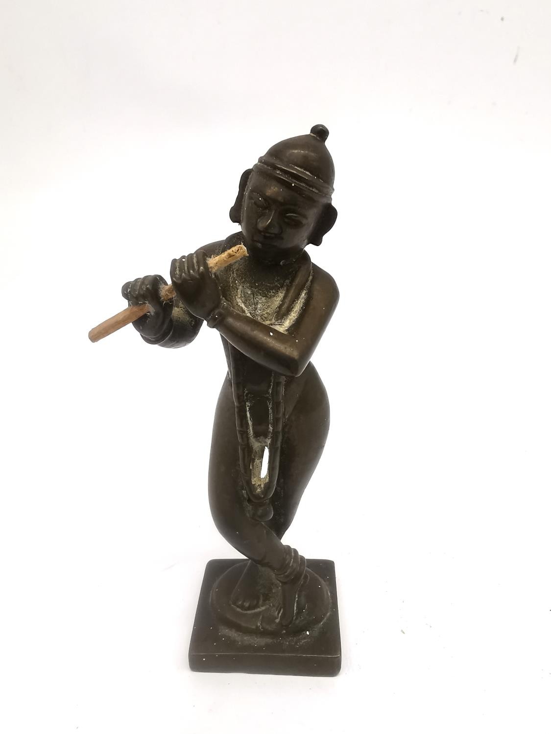 A 19th century Indian bronze figure of Krishna in Tri-bhang stance and playing the flute. H.12.5cm.