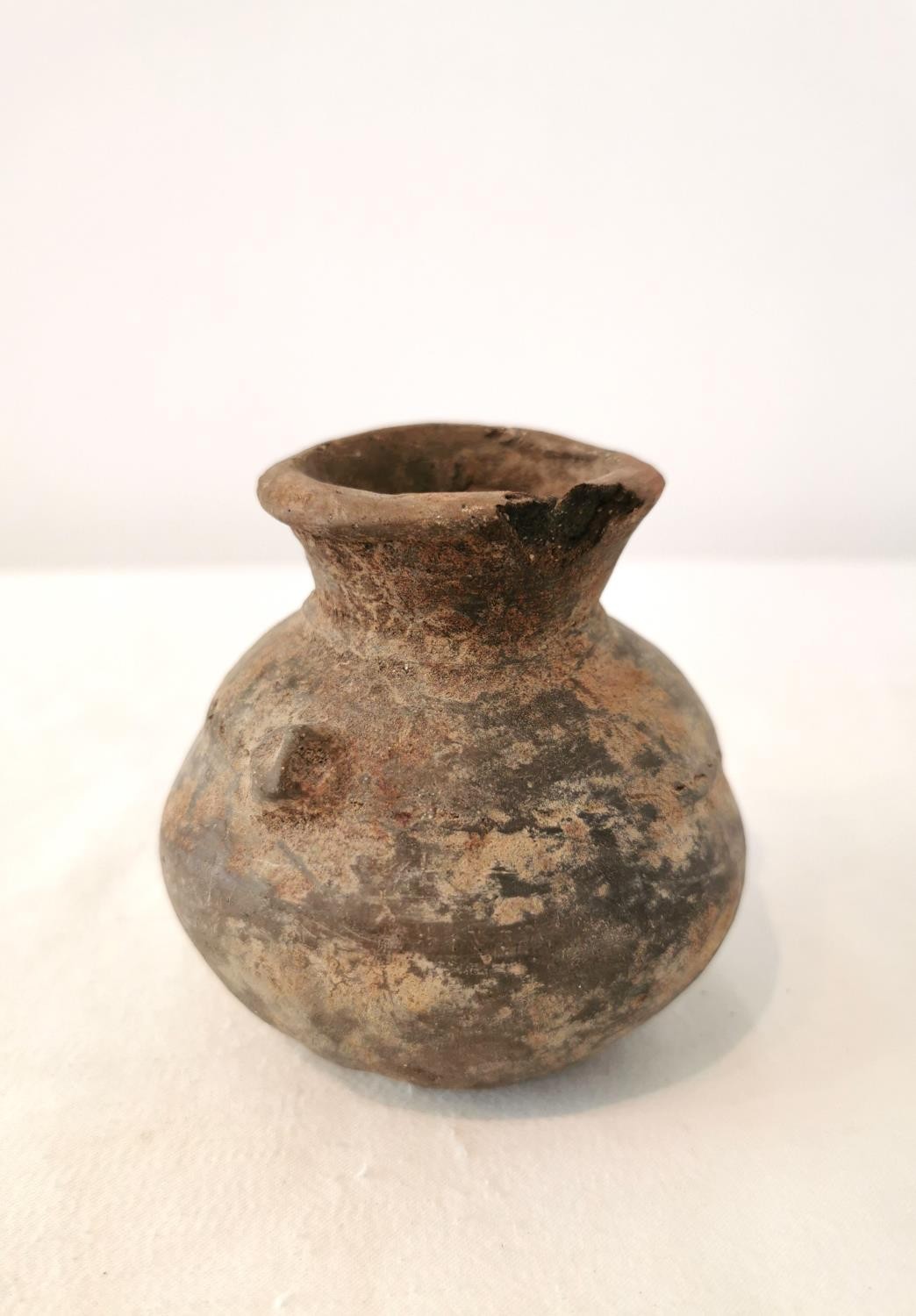 A Pre-Colombian terracotta vessel with rounded bottom and two small protrusions on the side. H.9.5 - Image 2 of 6