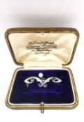 A leather boxed Belle Époque stylised scrolling foliate design white metal (tests as platinum)