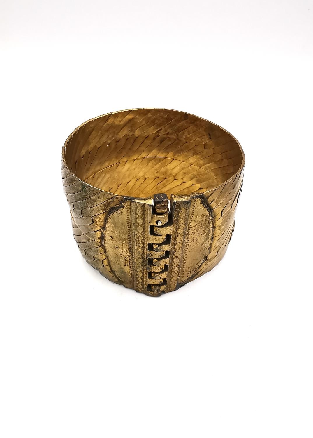 A Grecian style woven brass hinged pin cuff bangle. W.4.3 aperture 5.7 x 5.4cm