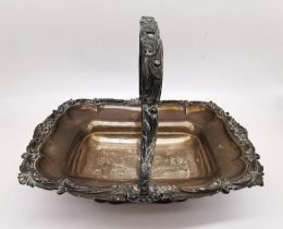 A Georgian sterling silver swing handle fruit basket with sculptural shell and scrolling foliate