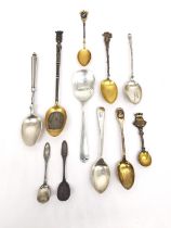 A collection of eleven 19th century silver, white metal and silver plated souvenir spoons of various