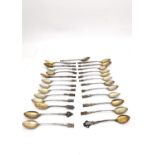 A collection of twenty seven early 20th century silver plated and white metal souvenir spoons,