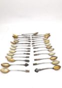 A collection of twenty seven early 20th century silver plated and white metal souvenir spoons,