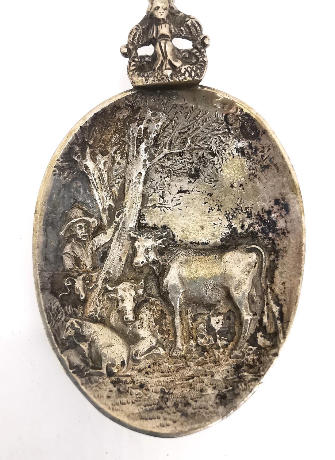 Two early 20th century silver libation spoons, one Dutch depicting a rural scene of cows and - Image 8 of 9