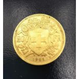 A 20F Swiss gold coin dated 1922. Diameter 2.1cm. Weight 6.4g.