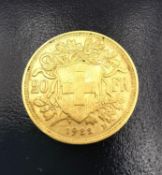A 20F Swiss gold coin dated 1922. Diameter 2.1cm. Weight 6.4g.
