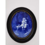 A framed 19th century Royal Doulton oval blue and white ceramic wall plaque decorated with girl with