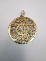 A gold plated pierced mongram pendant with acanthus leaf detailing. Diameter 4cm. Weight 5.06g