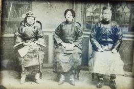 A Chinese framed and glazed 19th century black and white photograph depicting three Chinese people