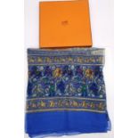 A boxed Hermes 'Chasse en Inde' (blue border) silk scarf by Michel Duchene, 1986. 132x112cm