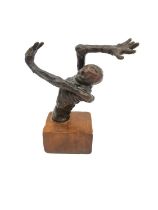 A bronze sculpture of a half skeleton with arm outstretched over its head. Unsigned. Mounted on