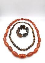 A silver and specimen agate articulated bracelet along with two carnelian and tiger's eye bead
