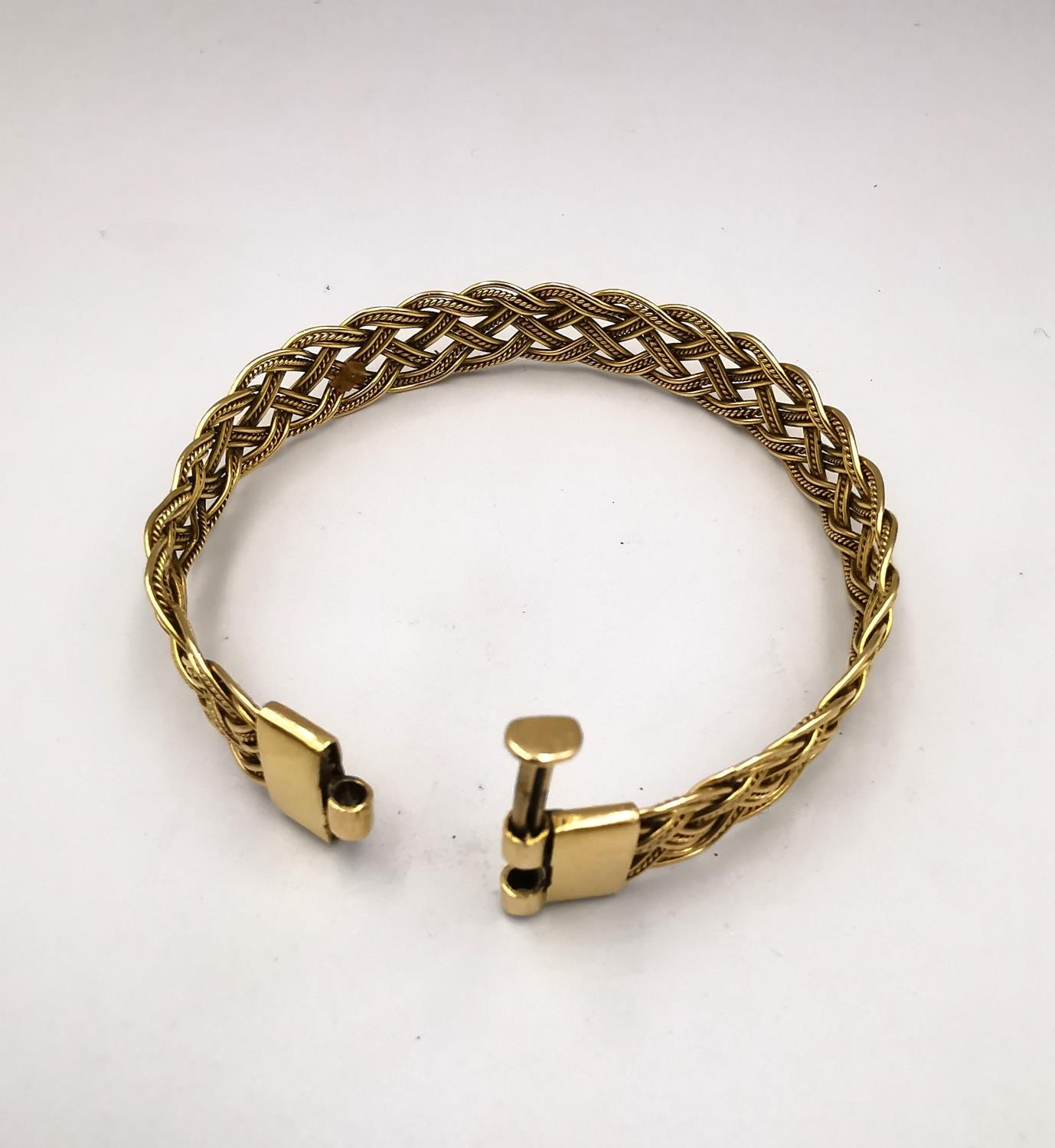 A woven gold plated wirework plaited bracelet with pin fastening. Diameter 6cm. Weight 18.62g. - Image 6 of 10