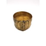 A Grecian style woven brass hinged pin cuff bangle. W.4.3 aperture 5.7 x 5.4cm