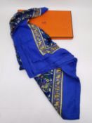 A boxed Hermes 'Chasse en Inde' (blue border) silk and cashmere scarf the by Michel Duchene, 1986.