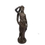 A 19th century bronze sculpture of a classical lady in draping robes removing her head cloth,