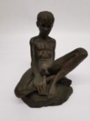 Neil Godfrey, British, b.1937, a bronzed resin seated nude of a young man. Signed and dated 1985.