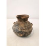 A Pre-Colombian terracotta vessel with rounded bottom and two small protrusions on the side. H.9.5