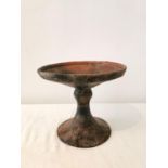 A Pre-Colombian terracotta pedestal dish, with carved and grooved decoration at rim. ( base and