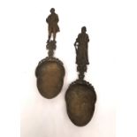 Two 19th century Dutch brass libation spoons with figurative finials and engraved detailing to the