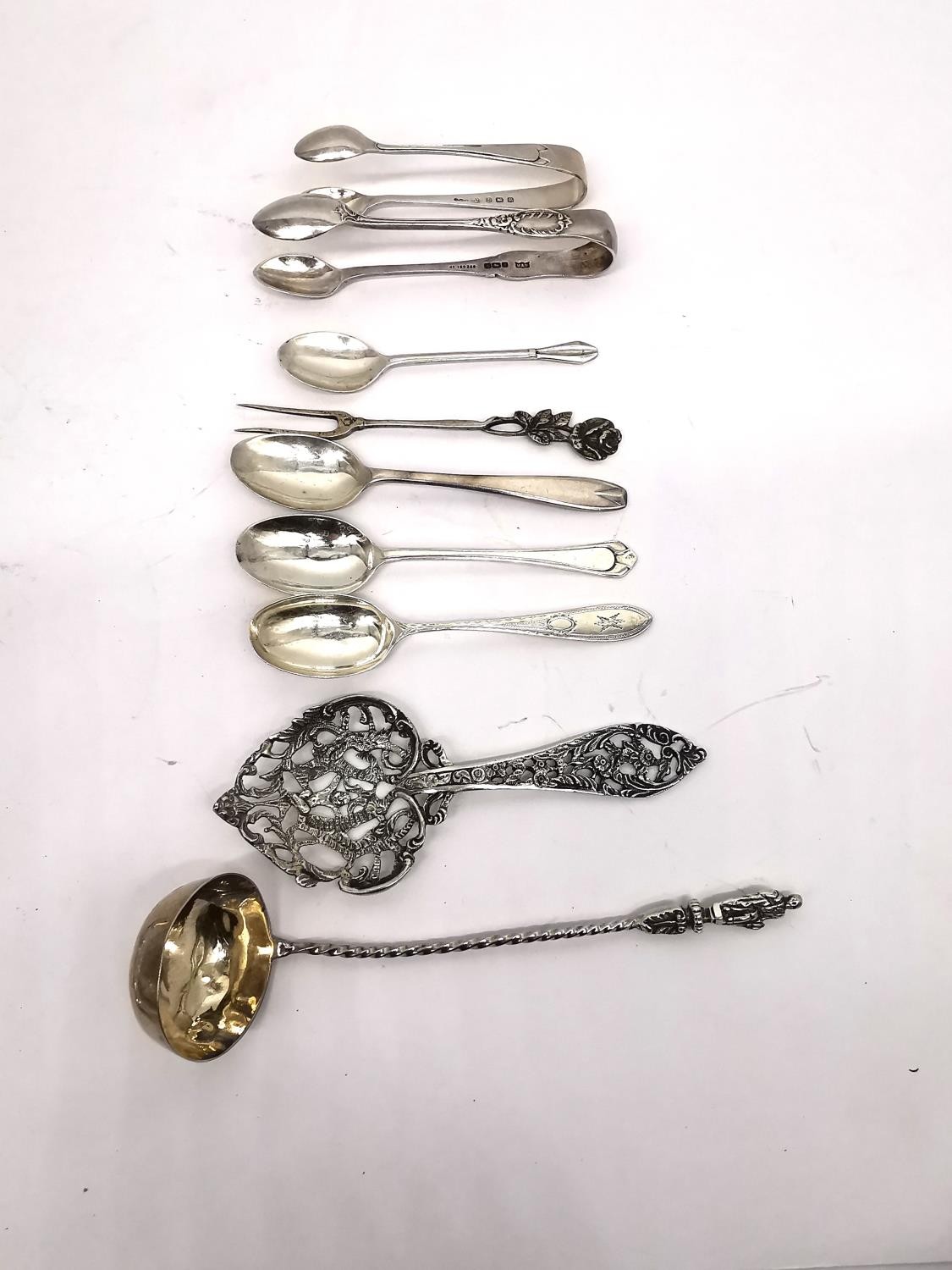 A collection of silver teaspoons, two pairs of sugar tongs, a pickle fork, a small sauce ladle and a - Image 15 of 16