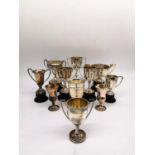 A collection of eleven silver and white metal golfing trophies with winners and competition