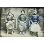 A Chinese framed and glazed 19th century black and white photograph depicting three Chinese people