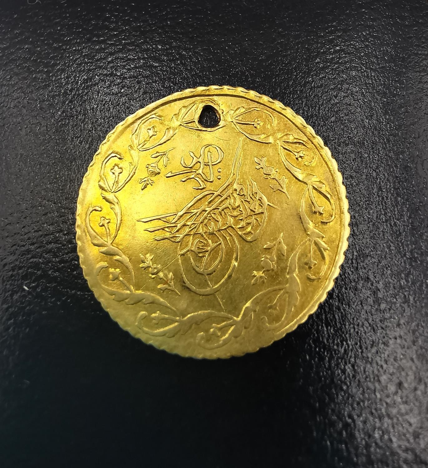 A Turkish 1 cedid gold coin, Mahmud II (1808-1839). (holed) Diameter 2cm. Weight 1.52g. - Image 2 of 3
