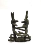 A Tribal bronze erotic sculpture of two bearded mythical creatures fighting. H.12 L.10.5 W.7cm.