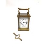 A late 19th century brass leather cased travelling carriage clock with skeleton movement and key.