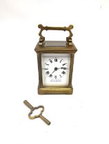 A late 19th century brass leather cased travelling carriage clock with skeleton movement and key.