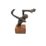 A bronze sculpture of a half skeleton with arm outstretched over its head. Unsigned. Mounted on